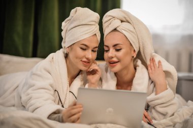 beautiful young women with towel and towels in the bathroom