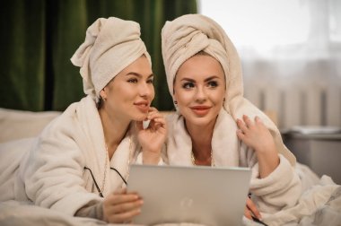 beautiful young women with towel and towels in the bathroom