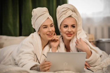 beautiful young women with towel and towels in the bathroom