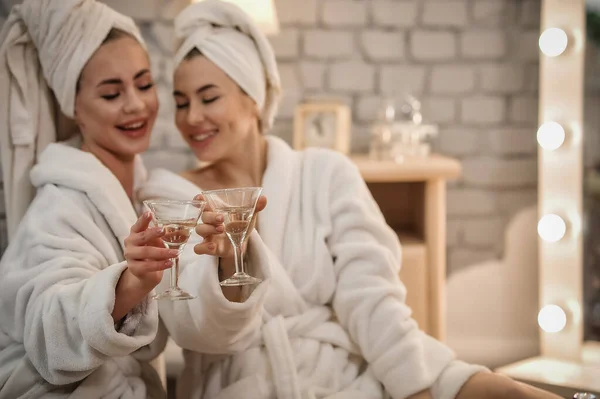 beautiful young women in bathrobes and bathrobe with towel in bathroom