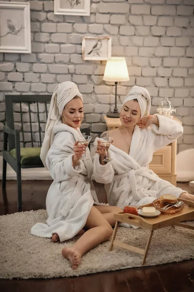 Beautiful Young Women Bathrobe Towel Sitting Sofa Spa Salon — Stock fotografie