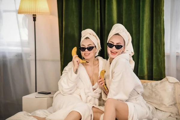Two Beautiful Women Bathrobes Drinking Juice Talking Mobile Phone While — 스톡 사진