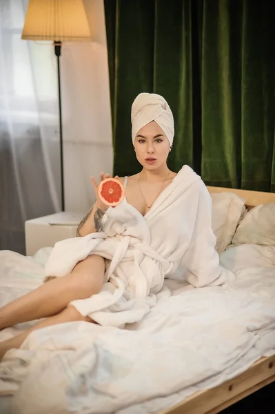 Beautiful Young Woman Bathrobe Mask Lying Bed Bedroom — Zdjęcie stockowe