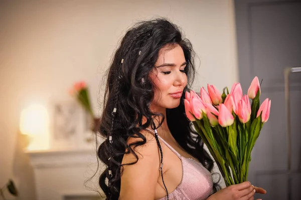 beautiful young woman with tulips in her hands