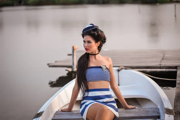 stock image girl in a swimsuit and sunglasses on a yacht near the river