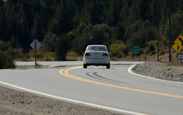 white car driving on the road with asphalt. bariloche ring road