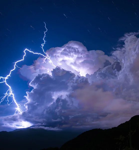 Blue sky, white clouds, lightning and thunder. Huge storm clouds announcing the approach of storms and the coming of storms.