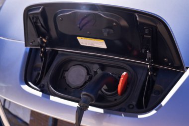 PAMPLONA, NAVARRA SPAIN JANUARY 13 2022: Electric car charging next to charging station