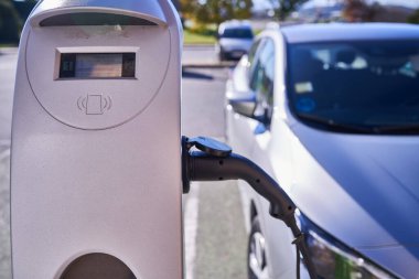 PAMPLONA, NAVARRA SPAIN JANUARY 13 2022: Electric car charging next to charging station