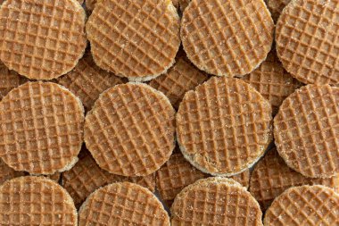 Full frame background of many Dutch syrup waffle cookies (translation: stroopwafels) from above