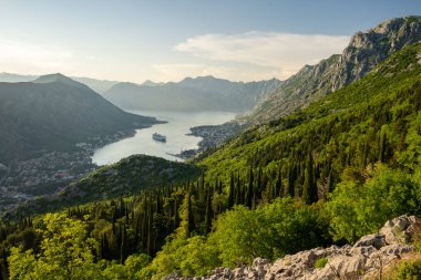 View over Bay of Kotor from above with sky and green mountains, Montenegro, Europe