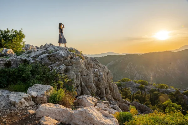 A woman overlooking the bay of Kotor at sunset, Montenegro , horizontal