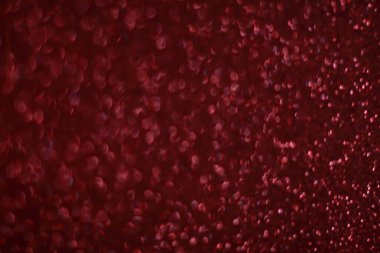 Bokeh odaklı ışıklarla kırmızı parıltılı soyut arkaplan