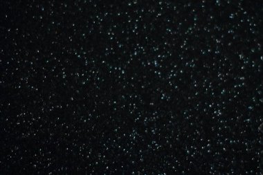 Siyah arkaplanda uçan toz parçacıkları