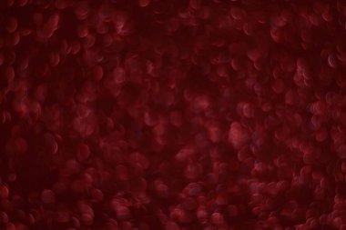 Bokeh odaklı ışıklarla kırmızı parıltılı soyut arkaplan