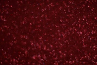 Bokeh odaklı ışıklarla kırmızı parıltılı soyut arkaplan