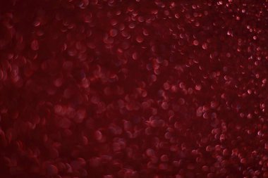 Bokeh odaklı ışıklarla kırmızı parıltılı soyut arkaplan