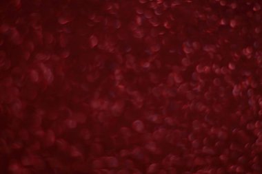 Bokeh odaklı ışıklarla kırmızı parıltılı soyut arkaplan