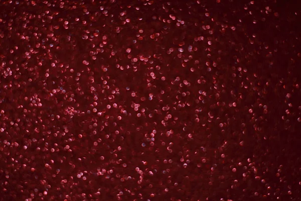 Bokeh odaklı ışıklarla kırmızı parıltılı soyut arkaplan