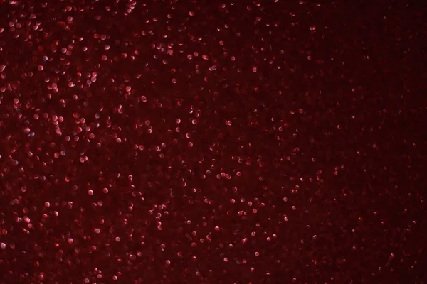 Bokeh odaklı ışıklarla kırmızı parıltılı soyut arkaplan