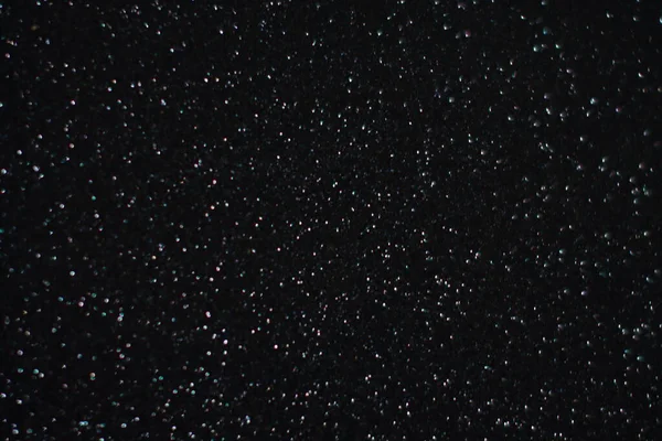 Siyah arkaplanda uçan toz parçacıkları