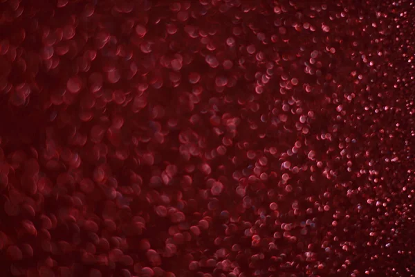 Bokeh odaklı ışıklarla kırmızı parıltılı soyut arkaplan