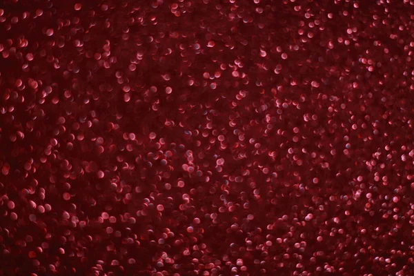 Bokeh odaklı ışıklarla kırmızı parıltılı soyut arkaplan