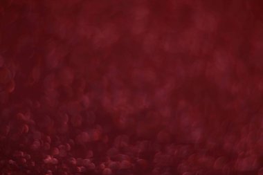 Bokeh odaklı ışıklarla kırmızı parıltılı soyut arkaplan