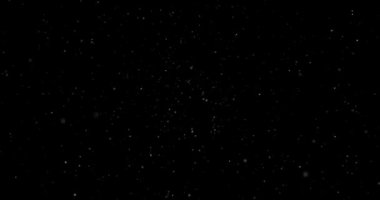 Animation with small white particles flying randomly on black background