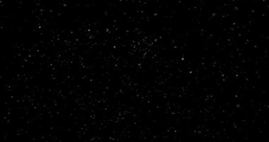 Animation with small white particles flying randomly on black background