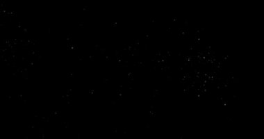 Animation with small white particles flying randomly on black background