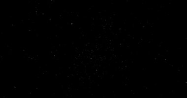 Animation with small white particles flying randomly on black background