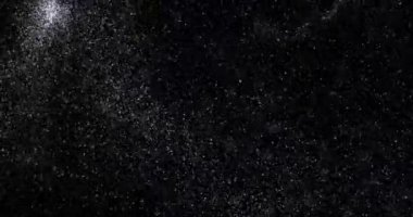 Siyah zemin üzerinde rastgele uçan küçük beyaz parçacıklara sahip video