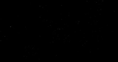 Animation with small white particles flying randomly on black background