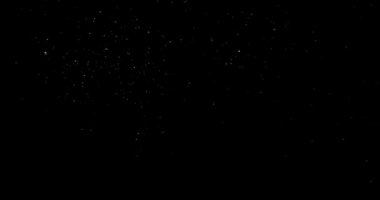 Siyah zemin üzerinde rastgele uçan küçük beyaz parçacıklara sahip video
