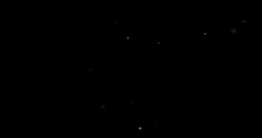 Siyah zemin üzerinde rastgele uçan küçük beyaz parçacıklara sahip video