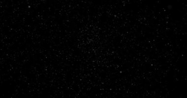 Animation with small white particles flying randomly on black background