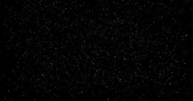 Animation with small white particles flying randomly on black background