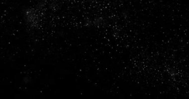 Siyah zemin üzerinde rastgele uçan küçük beyaz parçacıklara sahip video