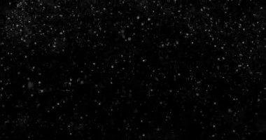 Siyah zemin üzerinde rastgele uçan küçük beyaz parçacıklara sahip video