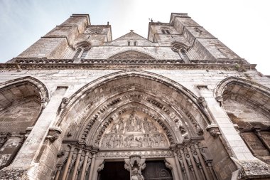 LES ANDELYS, FRANCE, APRIL 23, 2022 : exteriors and architectural details of the portal entrance of Our Lady collegiate church