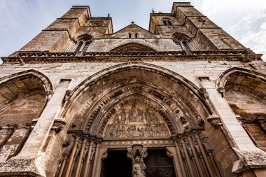 LES ANDELYS, FRANCE, APRIL 23, 2022 : exteriors and architectural details of the portal entrance of Our Lady collegiate church