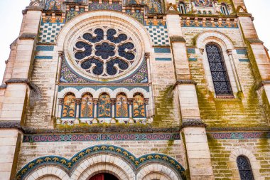 BRIARE, LOIRET, FRANCE, MAY 06, 2022 : exteriors decors and mosaics details of Saint Etienne church