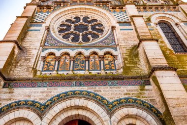 BRIARE, LOIRET, FRANCE, MAY 06, 2022 : exteriors decors and mosaics details of Saint Etienne church