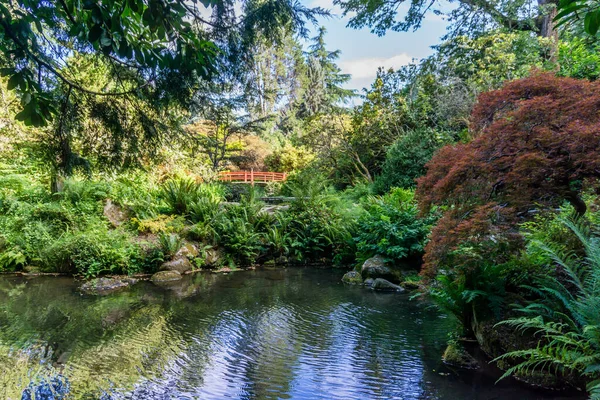A red walking bridge in a garden in Renton, Washington.