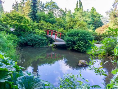 A red walking bridge in a garden in Renton, Washington.