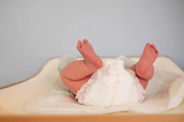 Baby on changing table staying alone without control. — Stock Photo, Image