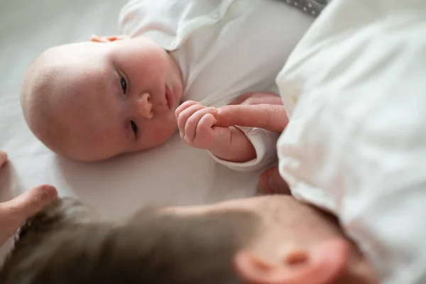 Sleeping father and cute child resting together in bed. — Stock Photo, Image