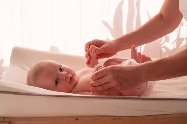 Mother massaging her child hands at home — Stock Photo, Image