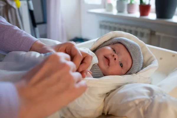 Putting on warm clothes on baby girl preparing for a walk on cold winter day. — Stock Photo, Image